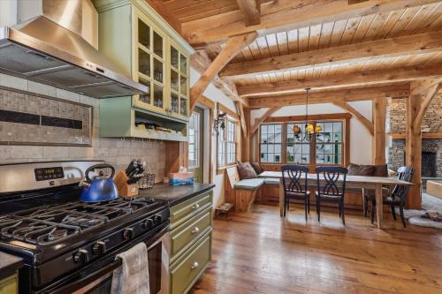 a kitchen with a stove and a dining room at Village Lodge in Stowe