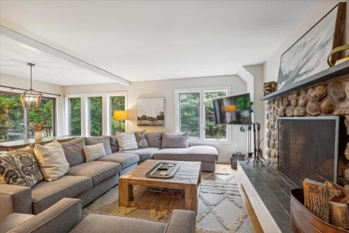 a living room with a couch and a fireplace at Topnotch 384D in Stowe Fork