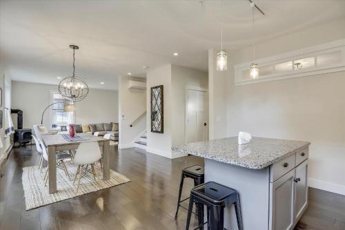 a kitchen and living room with a counter and a table at Scharkie Ski Haus in Stowe