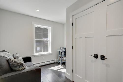 a white room with a door and a chair at Scharkie Ski Haus in Stowe