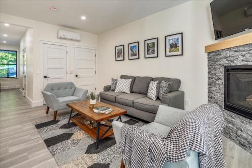 a living room with a couch and a fireplace at Village Hilltop in Stowe