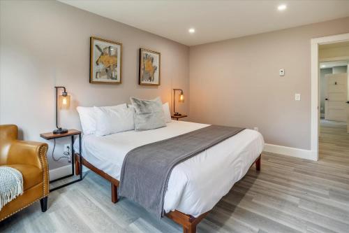 a bedroom with a large bed and a chair at Village Hilltop in Stowe