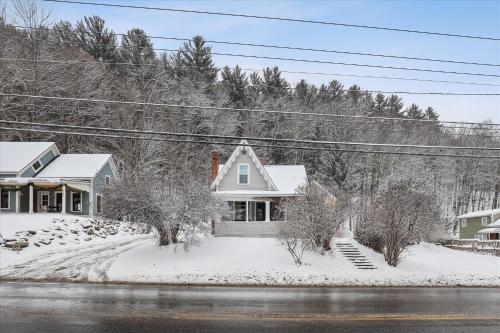 a house is covered in snow at The Cozy Villager in Stowe