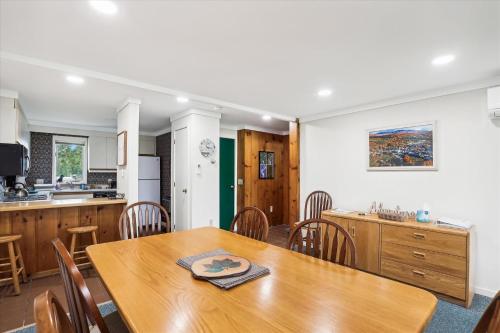 a kitchen and dining room with a wooden table and chairs at Village Green 10C in Stowe