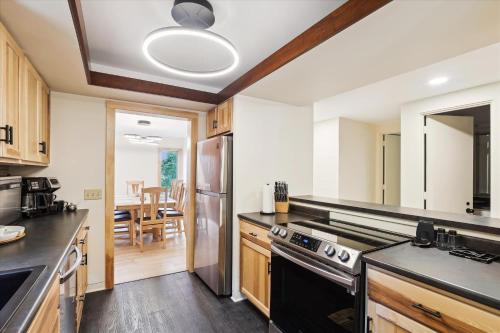 a kitchen with stainless steel appliances and a dining room at The Mercer House in Stowe