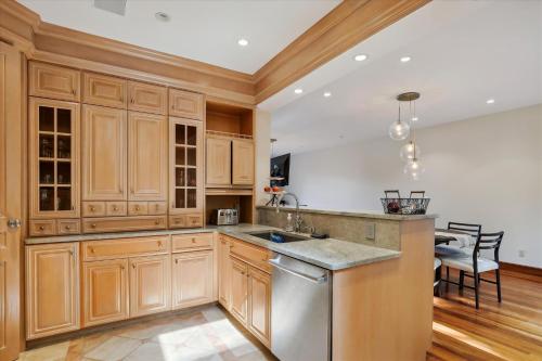 a kitchen with wooden cabinets and a sink at Stowe Haven in Stowe