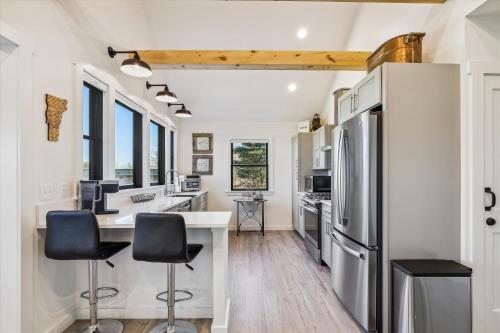 a kitchen with a counter and two stools at Sterling Ridge View in Stowe