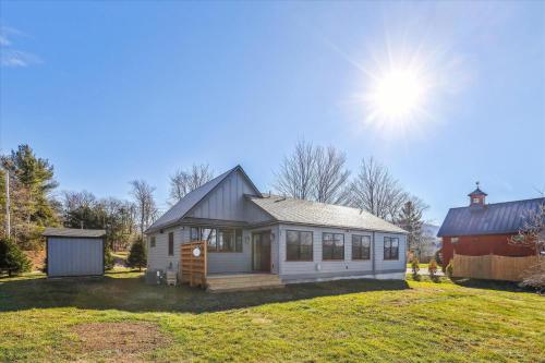 a small white house on a yard with a barn at Sterling Ridge View in Stowe