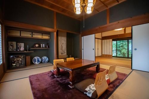 a dining room with a wooden table and chairs at Kamakurayama Farm - B&B Satoyama in Uda