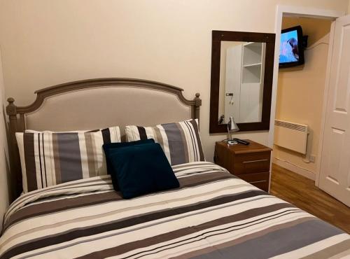 a bedroom with a bed with a blue pillow on it at Market Street Aberdeen Apartment in Aberdeen