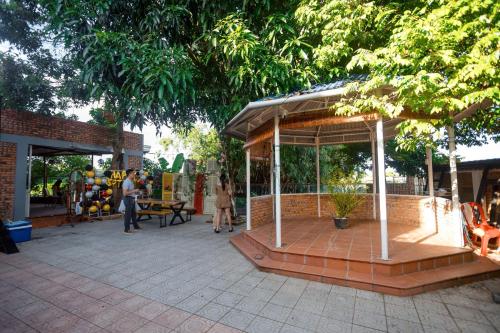 a gazebo in a park with people walking around at Lúa homestay in Hue