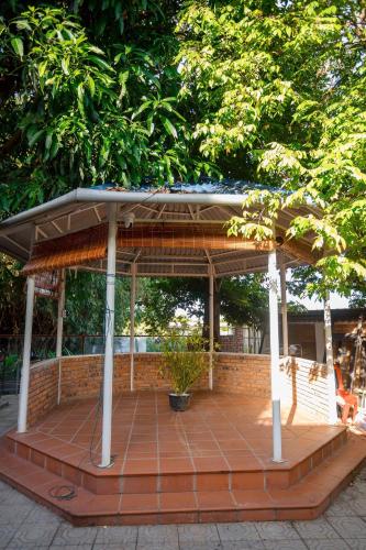 a pavilion with a roof on top of a patio at Lúa homestay in Hue
