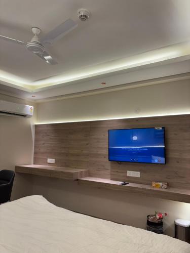 a bedroom with a flat screen tv on a wall at Sun twilight studio and hotal in Greater Noida
