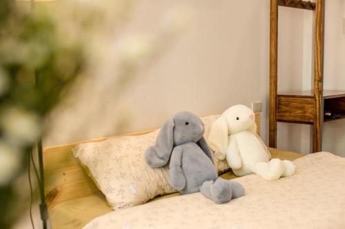 a group of stuffed animals sitting on a bed at Lúa homestay in Hue