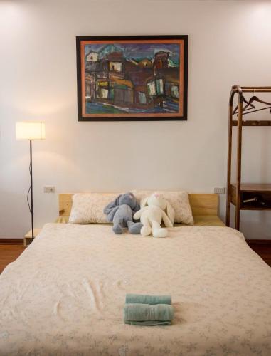 two stuffed animals sitting on top of a bed at Lúa homestay in Hue