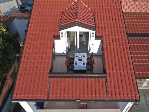 an overhead view of a red roof with a table and chairs at Apartments Petra in Njivice