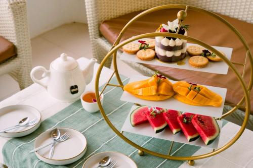 a plate of food on a table with desserts at Nontawa Villa Doichang in Ban Huai Khai