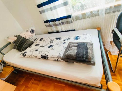 a small bed in a room with a window at Ruhige Zimmer in WG in Laupheim