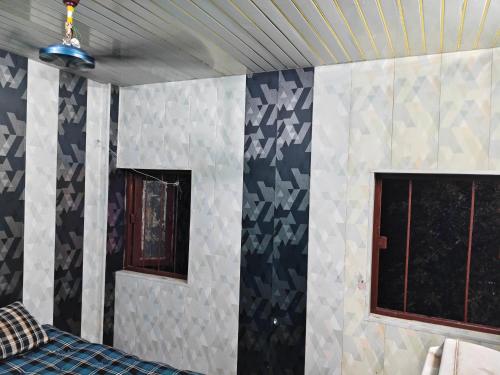 a room with blue and white walls and windows at City Guest house in Patna
