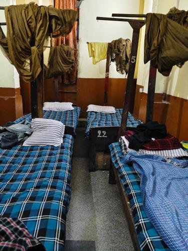 a room with three bunk beds in it at City Guest house in Patna