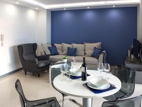 a living room with a couch and a table and chairs at Apartments Petra in Njivice