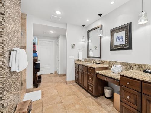 a bathroom with two sinks and a mirror at Seasons at Sandpoint - Managed by Elite Alliance in Sandpoint