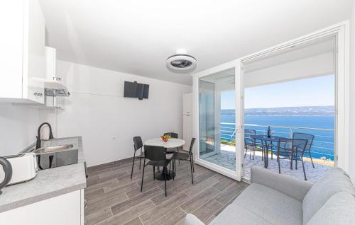 a kitchen and living room with a view of the ocean at 2 Bedroom Stunning Apartment In Stanici in Stanići