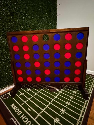 a bed with red and blue polka dots on it at Luxury Villa- Hot Tub-King Bed Suite-Fenced Yard-Game Room-Fire Pit-Ski in East Stroudsburg