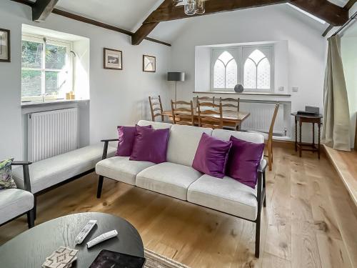 a living room with purple pillows on a couch at Priory Stile in Haverfordwest