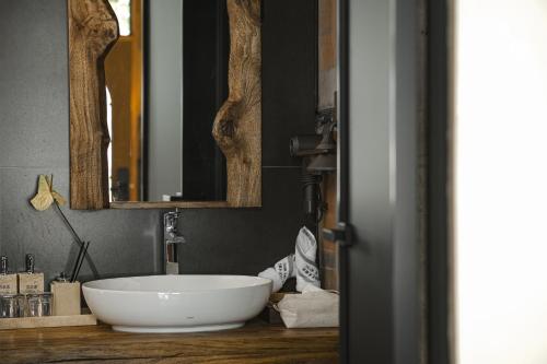 a bathroom with a large white sink and mirrors at Yang Liping Xianguo'an Moon Palace Villa, Shuanglang, Dali in Dali Shuanglang