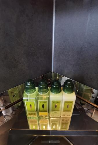 a group of four bottles of oil on a counter at Yang Liping Xianguo'an Moon Palace Villa, Shuanglang, Dali in Dali Shuanglang