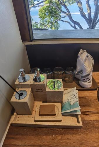 a group of boxes sitting on a table next to a window at Yang Liping Xianguo'an Moon Palace Villa, Shuanglang, Dali in Dali Shuanglang
