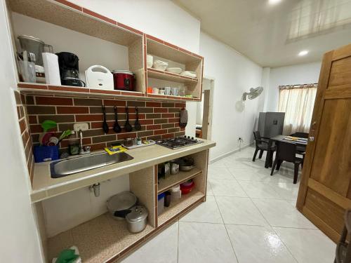 a kitchen with a sink and a brick wall at Apartaestudio en Tolú - Itze solaris in Tolú