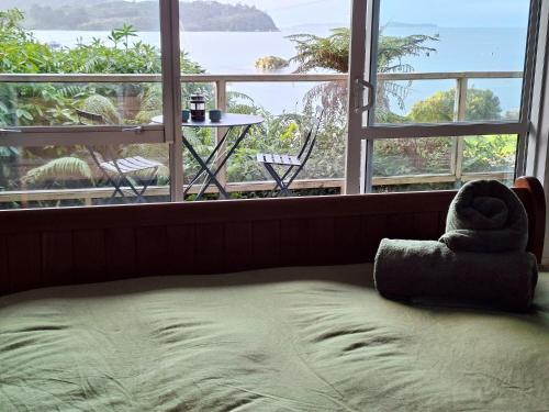 a bed with a stuffed animal on it in front of a window at Greenvale Bed and Breakfast in Oban