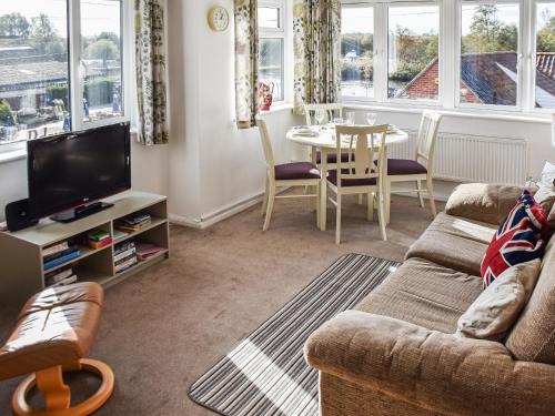 a living room with a couch and a table at River View in Horning