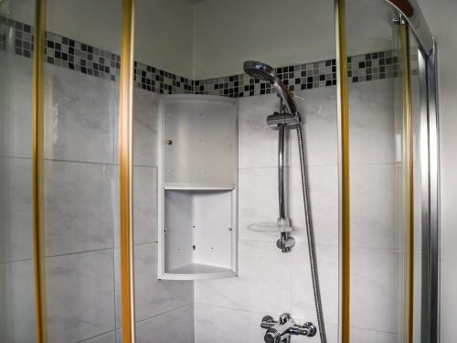 a shower with a glass door in a bathroom at River View in Horning