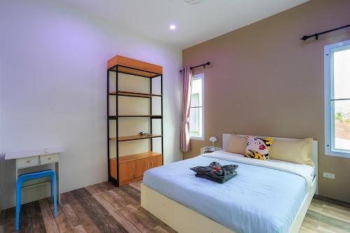 a bedroom with a large bed and a desk at V228 Renovated 3BR Pool Villa Near Top Beaches in Bang Rak Beach