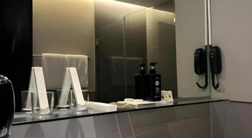 a bathroom counter with a mirror and a phone at F1 Hotel Manila in Manila