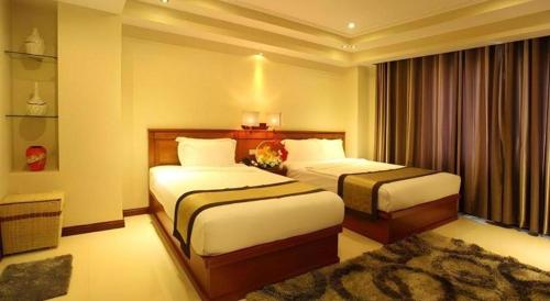 a hotel room with two beds and a window at Au Lac 2 Hotel in Ho Chi Minh City