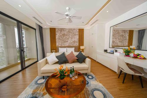 a living room with a couch and a table at Wyndham Garden Grandworld Phu Quoc in Phu Quoc
