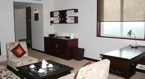 a living room with a couch and a table at BMC Ha Tinh hotel in Ha Tinh