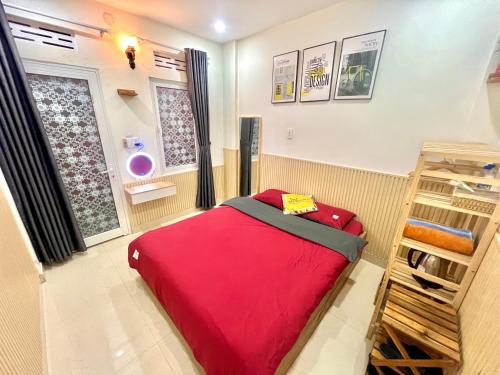 a bedroom with a red bed in a room at Cloud River Homestay in Da Lat