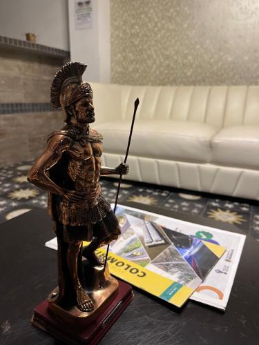 a statue of anubis on a table in a living room at Hotel Roma VIP Pereira in Pereira