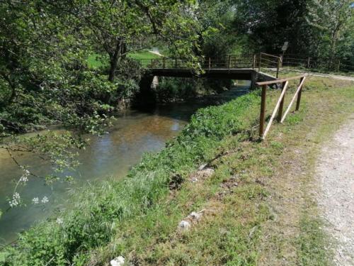 a bridge over a river with a bridge istg at Farmhouse in Giano dell'Umbria in Giano dellʼUmbria