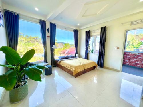 a bedroom with a bed and a large window at Cloud River Homestay in Da Lat