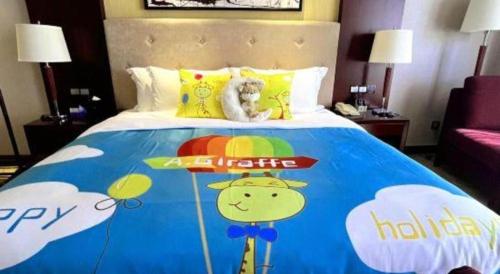 a bedroom with a bed with a hello kitty bedspread at Wuhan Soluxe Hotel in Wuhan