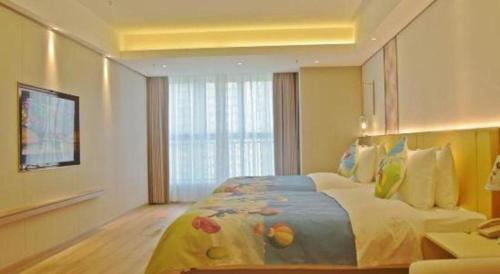 a bedroom with a large bed with a large window at Chengdu Antai Century Hotel in Chengdu