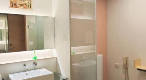 a bathroom with a sink and a mirror at Catic Hotel--Adjacent Buliding in Zhuhai
