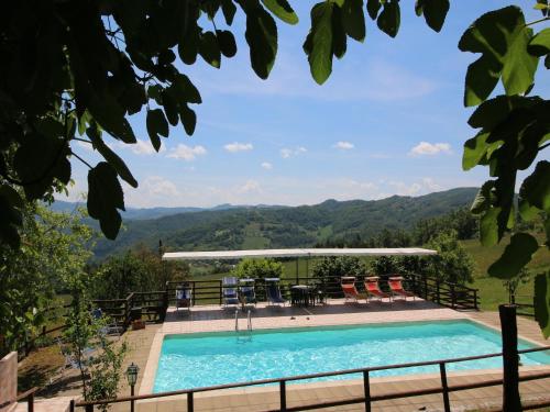 a swimming pool with a view of the mountains at Farmhouse in Apecchio with Swimming Pool, Terrace, Garden in Apecchio