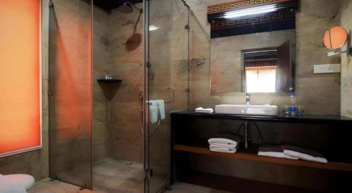a bathroom with a shower and a sink at Hotel Valley Thimphu in Thimphu